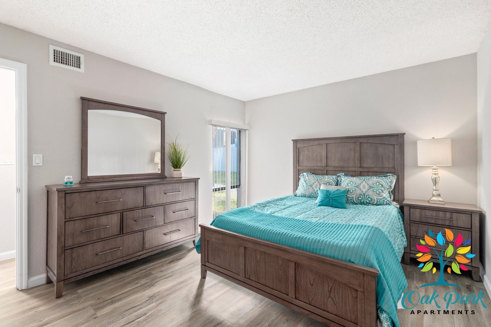 A bedroom with a bed, dresser, and mirror.